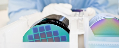 Closeup of a worker with safety gloves inspecting small samples