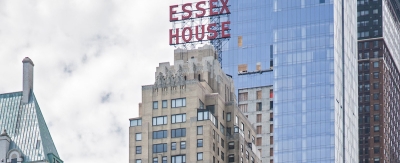 Exterior of a large high rise building with a large sign that reads 
