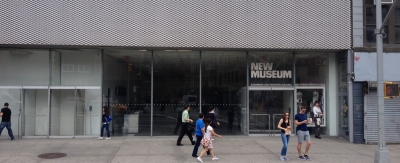 The exterior of a museum along a busy street in NYC.