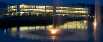 An image of Olympus America Data Center from the front of the facility near a pond and fountain