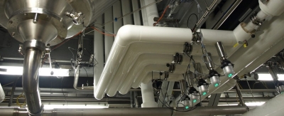 An image of pipes and controls that are part of the beer brewing process at Sam Adams